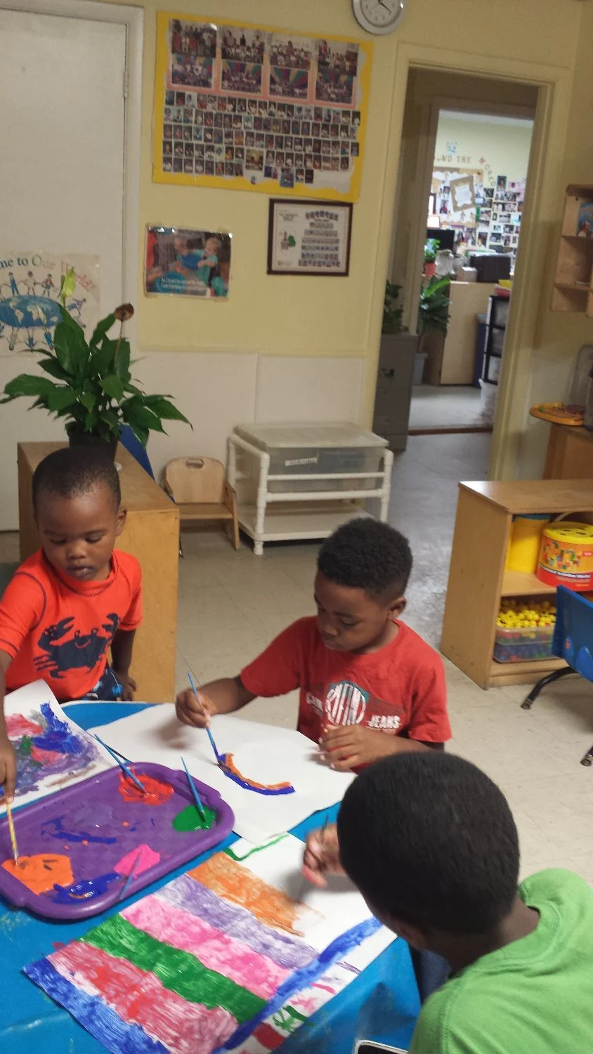 Preschooler painting at NECFC daycare in Tallahassee